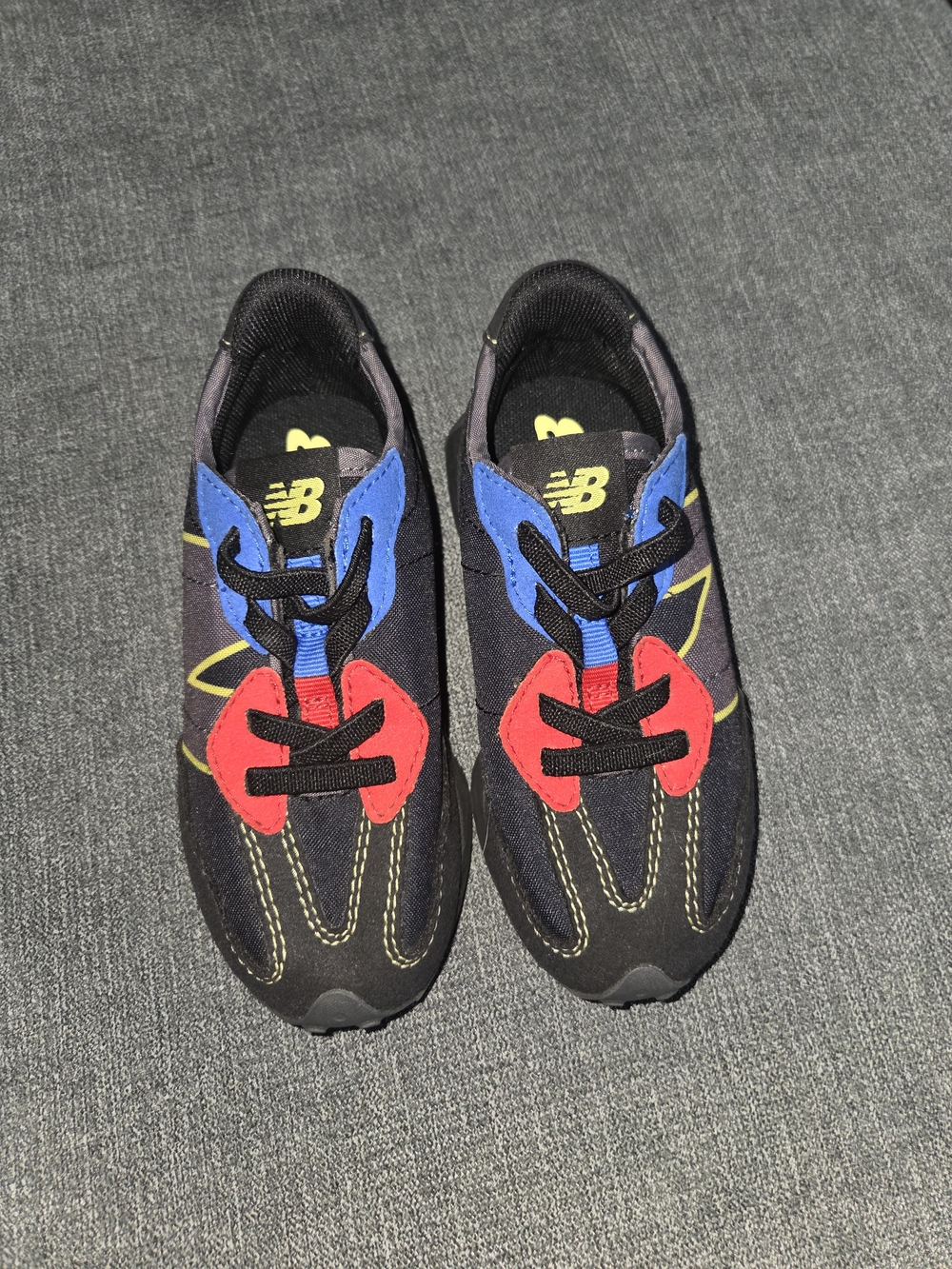 New Balance Kids Black Red Blue Yellow Accent Sneakers
